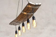 several light bulbs hanging from a wooden beam