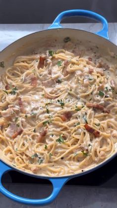 a blue skillet filled with pasta and meat