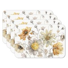 four placemats with yellow and white flowers on the front, one has an orange flower