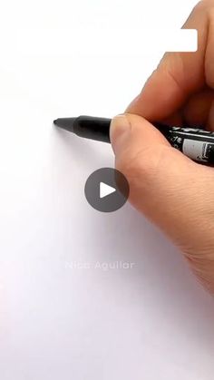 a person is writing on a piece of paper with a pen in their left hand