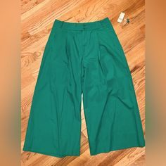 Nwt Pleated, High Waisted Wide-Legged Crop Pants. Tall Size, But Doesn’t Have To Be A Tall Person To Wear Them. See Pics For Measurements. Not Sure If The Color Shows Through, But I Would Describe As A True Christmas Green. Beautiful Color Perfect For Holiday Parties With A Sweater Or Button Down Shirt. Please Ask Any Questions You May Have! Will Ship Right Away In Time For Any Christmas Parties! Chic Green Cropped Leg Bottoms, Chic Green Cropped Bottoms, Green Cropped Leg Bottoms, Green Cropped Leg Bottoms For Work, Green Wide Leg Culottes For Spring, High Waist Green Capris For Spring, Spring Green Wide-leg Culottes, Green Cropped Leg Summer Pants, Summer Cropped Leg Green Pants