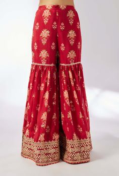 This pretty ensemble in our floral jaal, with an intricate border embroidery. The short peplum adds the flattering drape and ease to the fit. The exquisite dupatta embroidered in sequins and gold thread, and voluminous sharara adds a feminine grace. Festive Peplum Lehenga With Embroidery, Festive Embroidered Peplum Lehenga, Red Anarkali Style Sharara In Chinon, Wedding Sharara With Chikankari Embroidery And Peplum Style, Embroidered Peplum Lehenga For Eid, Traditional Peplum Anarkali Set For Designer Wear, Designer Red Sharara In Chinon, Festival Peplum Sets With Gota Work, Peplum Festival Sets With Gota Work