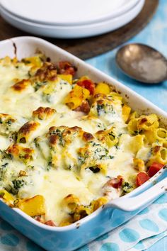 a casserole dish with cheese and vegetables in it