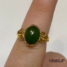 Gold colored ring with gold hearts on each side of a medium jade colored stone. Vintage ring inventory form my great grandmother's restaurant and gift shop in Silverton, CO that she owned and operated from the 1960s to 1996. Style 1358SJP Sizes available: Size 4 - qty 1 Size 4.5 - qty 2 Size 5 - qty 2 Size 5.5 - qty 1 Size 6 - qty 1 Size 6.5 - qty 2 Size 7 - qty 1 Gold Jade Cabochon Rings, Jade Rings Oval Cabochon For Anniversary, Gold Rings With Jade Cabochon, Gold Jade Emerald Ring, 1996 Style, Gold Color Ring, Gold Hearts, Colored Stone, Color Ring