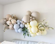 balloons and flowers are hanging on the wall