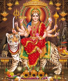 the hindu goddess sitting on top of a tiger