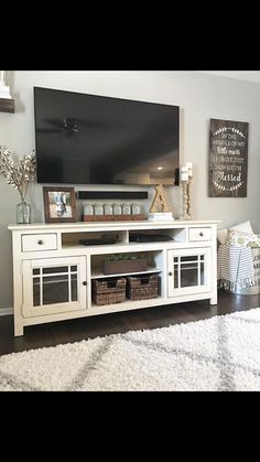 a white entertainment center in a living room