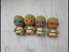 four small crocheted turtle dolls sitting next to each other