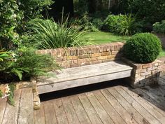 a wooden bench sitting on top of a wooden deck