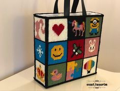 a handbag made out of squares with pictures on the front and sides, all in different colors