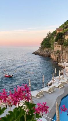 an outdoor swimming pool next to the ocean