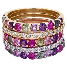 3.06 Carat Multi Color Sapphire and Diamond Stackable Gold Bands Beautifully curated Stackable Bands with Multi Color Sapphires and Diamonds! These bands are so versatile and a best seller for us! 3.06 Carats Diamond Sapphire 14K Gold Stackable Bands Item Specs.: 33 Multi-Colored Sapphires: 2.50 cts. 30 Round Cut Diamonds: 0.56 cts. (Clarity: SI2, Color: F) 14K Tri-Color Bands: 7.4 grams They are stackable and versatile; can be worn together or separate! Band size is a 6 and can be re-sized at n Sapphire And Diamond Band, Red Sapphire, Sapphire Band, Stackable Bands, Color Bands, Deco Jewelry, Diamond Rings Bands, Sapphire Stone, Art Deco Jewelry