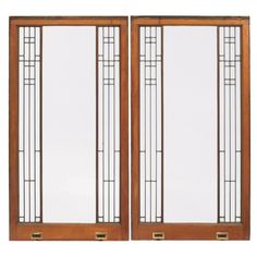 a pair of wooden doors with glass panels