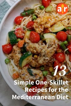 a white plate topped with pasta and veggies