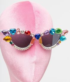 These dazzling sunglasses are set in a retro cat eye shape and accented with rainbow colored gemstones. Complete with molded nose pad. Each pair is unique and may not match images provided.Available while supplies last Multicolor Mirrored Sunglasses With Glass Lenses, Multicolor Mirrored Lens Sunglasses, Multicolor Mirrored Lens Sunglasses In Glass, Multicolor Mirrored Glass Sunglasses, Multicolor Cat Eye Sunglasses With Uv Protection, Party Cat Eye Sunglasses With Rhinestones, Fun Cat Eye Sunglasses For Party, Trendy Multicolor Cat Eye Sunglasses With Mirrored Lenses, Trendy Multicolor Mirrored Cat Eye Sunglasses