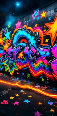 colorful graffiti art on the side of a wall in an empty parking lot at night