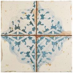 four tiles with blue and white designs on them