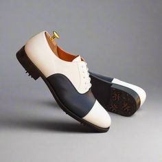 Characterized by its closed lacing style, the oxford is an elegant, classic, timeless style suitable for any occasion. The oxford is a staple shoe in any man’s wardrobe and can be dressed up or down. The Details: Materials: navy box calf + white box calf Lining: orange calf leather Sole: GOLF Last: Zurigo - Rounded toe for fraditional English Look The Fine Print: Shoe production timeline/shipping can vary from 15-30 days from the date of order. All shoes are handmade, small tinny changes or impe White Brogue Oxfords For Semi-formal Occasions, White Brogue-detailed Oxfords For Semi-formal Occasions, White Oxfords With Brogue Detailing For Semi-formal Occasions, White Business Dress Shoes With Rubber Heel Cap, Semi-formal White Oxfords With Brogue Detailing, White Oxford Dress Shoes With Rubber Sole, White Goodyear Welted Dress Shoes For Business, White Goodyear Welted Leather Shoes For Semi-formal Occasions, White Brogue Oxfords For Formal Occasions