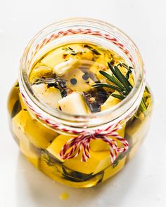 a glass jar filled with pickles and lemons