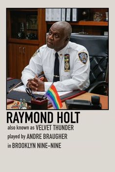 a man in uniform sitting at a desk with a rainbow flag on it and the caption says, raymond holt also known as velvet thunder played by