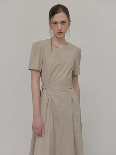 This product, designed as a neck strap belt dress, offers a fusion of modern and traditional elements, creating a piece that's both unique and versatile. With its understated elegance, it serves as a canvas for personal styling, whether with bold accessories or a minimalist approach. Its structure provides a flattering fit, while the addition of the neck strap adds a touch of contemporary flair. - The dress is meticulously tailored to accentuate the waistline with its belt detail.- Its knee-length cut strikes a balance between sophistication and comfort, suitable for various occasions.- The neck strap feature introduces a modern twist to the classic silhouette.- Constructed from a premium fabric, the dress ensures both durability and ease of movement. Modern Beige Dress For Formal Occasions, Elegant Beige Belted Mini Dress, Modern Beige Formal Dress, Bold Accessories, Belt Dress, Dress Beige, Understated Elegance, Classic Silhouette, Neck Strap