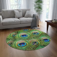 a living room with a couch and rug that has a peacock print on the floor