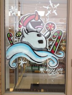 the window has been decorated with an image of a snowman and skis on it