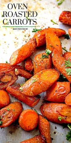 roasted carrots on a baking sheet with parsley sprinkled on top and the words roasted carrots written above them