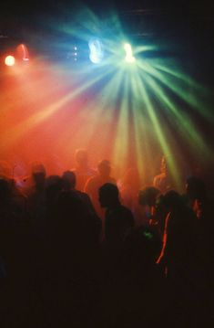 a group of people standing on top of a stage with bright lights in the background