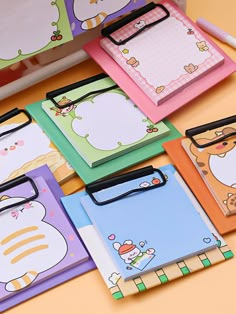 many different colored notebooks with cartoon animals on them