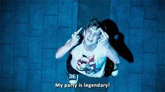 a man is jumping in the air with his hands up to his head while wearing a t - shirt that says my party is legend