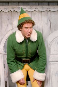 a man dressed in an elf costume sitting on a bench