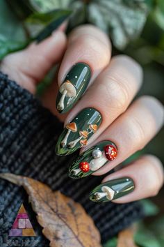 Get inspired by the mysterious depths of the forest with these dark green nail designs from NailHow.com. Combining the beauty of nature with a sleek, modern twist, these nails feature a subtle mushroom and botanical theme with 3D elements. Perfect for when you want to bring the outdoors in. See more captivating designs! Mushroom Forest Nails, Forest Nails Acrylic, Mushroom Fairy Nails, Forest Witch Nails, 3d Mushroom Nails, Dark Forest Nails, Forest Nails Designs, Green Forest Nails, Nature Inspired Nails