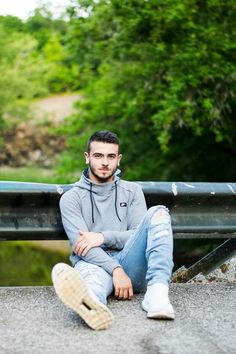 a man sitting on the ground with his legs crossed