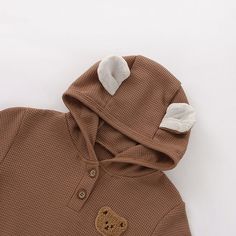 Made from Organic Cotton: An eco-friendly, breathable, and hypoallergenic fabric that’s gentle on delicate skin. Care Instructions: Machine wash on a gentle cycle, tumble dry on low. A Thoughtful Gift: Ideal for birthdays, holidays, or any day you want to make extra special for the little one in your life. Cute Brown Cotton Onesie, Brown Winter Onesie For Playtime, Beige Long Sleeve Onesie For Playtime, Brown Long Sleeve Tops For Playtime, Brown Fall Onesie For Playtime, Brown Onesie For Playtime In Fall, Fall Playtime Brown Onesie, Bear Ear Hoodie, Teddy Bear Ears