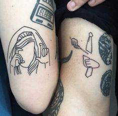 two people with tattoos on their legs