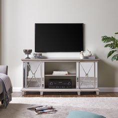 a flat screen tv sitting on top of a white entertainment center