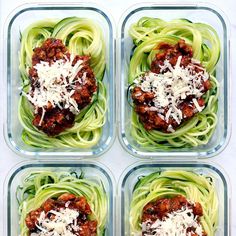 four plastic containers filled with different types of pasta and sauces on top of each other