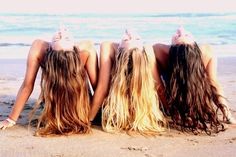 three women sitting in the sand with their backs turned to one another and texting, wanting to do the same thing as your best friend