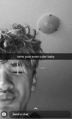 a black and white photo of a man with his hair blowing in the wind, text reads he's your even cuter baby send a chat