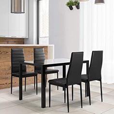 a dining room table with four chairs around it