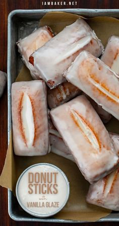 Overhead image of a metal tray fitted with parchment paper and filled with a small dish of glaze, and eight rectangular shaped donuts that are coated with a glaze. Donut Sticks Recipe, Donut Sticks, Glazed Donut, Fried Dough, Beignets