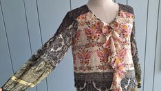 "#vintagebohochic This boho summer colorful blouse is in lightweight chiffon and lace. Classic paisley prints Ruffle front  3/4 sleeves Elastic waist Best fits : S and smaller M  Perfectly paired with denim outfits. Or with light color pants. In Measurements(taken flat): Bust: 17\" Waist: 14\" - 17\" elastic Total Length: 26\" Made in India Excellent vintage condition. To see more items, visit : www.etsy.com/shop/RetroTheory" Bohemian Blouse With Boho Print, Bohemian Patterned Blouse With Boho Print, Bohemian Boho Print Patterned Blouse, Bohemian Patchwork Blouse For Spring, Bohemian Spring Blouse With Patchwork, Bohemian Spring Patchwork Blouse, Spring Bohemian Patchwork Blouse, Bohemian Blouse With Lace Trim, Bohemian Multicolor Lace Trim Blouse