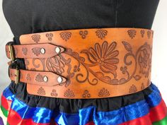 Winter Fire is a beautiful floral design created by Metis artist Victoria Scattergood. Our traditional hand-stamped leather belts are handcrafted with the utmost attention to detail and quality: Made from 9-10 oz vegetable-tanned leather (extremely thick) 4 inches wide Belts are adjustable up to 4 inches Intricate floral and geometric pattern stamping designs created by our Indigenous design team Hand dyed in-house in a range of natural finishes Require regular oiling to maintain durability and Native Leather Crafts, Navajo Sash Belt Designs, Thick Leather Belt, Native American Belt, Traditional Brown Leather Belt Buckles, Traditional Brown Belt Buckles With Matching Belt, Traditional Hand Tooled Brown Belt, Traditional Brown Belt Buckles, Adjustable Leather Belt Buckles, Traditional Style