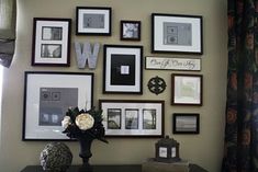 there are many framed pictures on the wall in this room, including flowers and vases