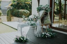 an outdoor ceremony setup with flowers and greenery