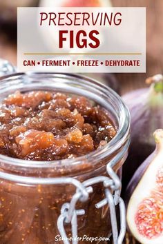 a jar filled with figs sitting on top of a table next to sliced figs