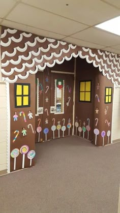 a room decorated in the shape of a gingerbread house with candy and candies on it