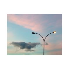 a street light and some clouds in the sky