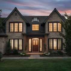 a large brick house with two story windows